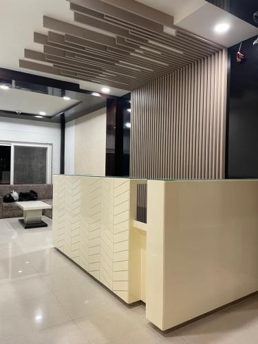 a lobby with a reception desk in a building at Hotel Royal Embassy in Tinsukia