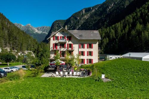 a house with a motorcycle parked in front of it at Auberge du Mont Blanc in Trient