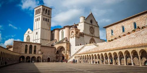 a large building with a clock tower and a church at B&B La Fisarmonica in Bastia Umbra