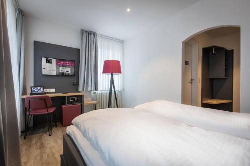 Ένα ή περισσότερα κρεβάτια σε δωμάτιο στο SMARTY Hotel Euler Homburg, Saar - KONTAKTLOSER SELF CHECK-IN