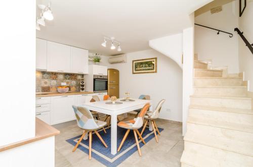 a kitchen and dining room with a table and chairs at Holiday Home Tezoro Royal in Dubrovnik