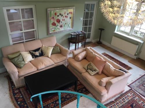 a living room with a couch and a table at Chalkcroft Lodge in Andover