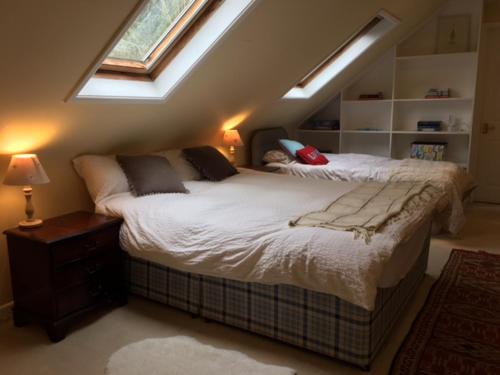 a bedroom with a large bed with a window at Chalkcroft lodge in Andover