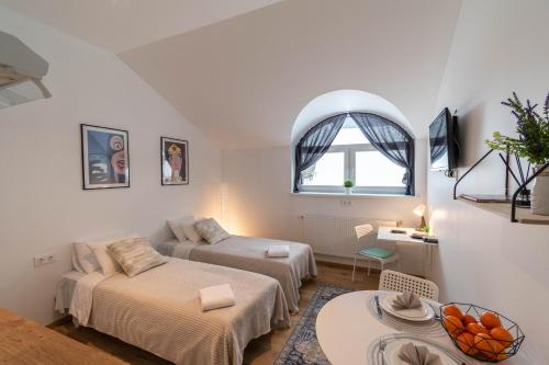 a living room with two beds and a couch at Apartments24 Spordi in Rakvere