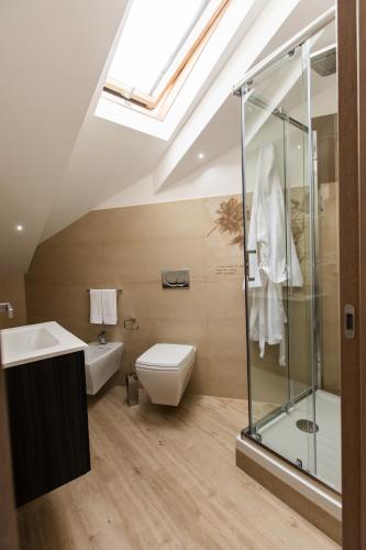 a bathroom with a shower and a toilet and a sink at Diamond apartment Agerola in Agerola