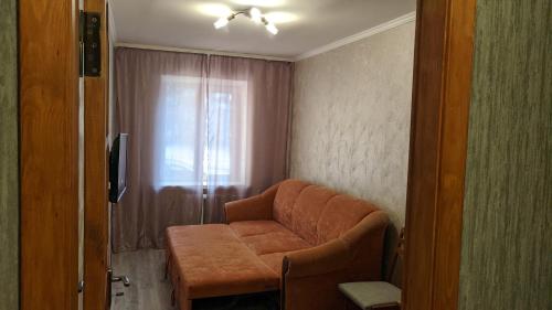 a living room with a couch and a window at Apartments near the Trinity Church on Dovzhenko Street,102 in Chernihiv