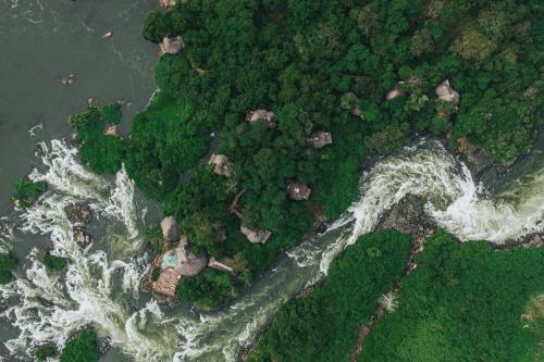 an aerial view of a river with trees and water at Lemala Wildwaters Lodge in Kangulumira