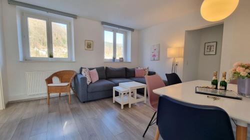 a living room with a couch and a table at Ferienwohnungen Flussufer - Neckargemünd Altstadt in Neckargemünd