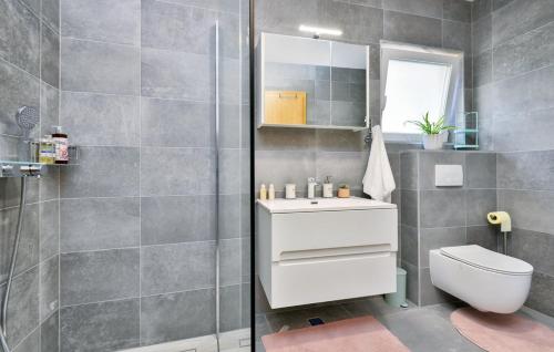 a bathroom with a toilet and a sink and a shower at Kalimero Apartman A1 in Križevci