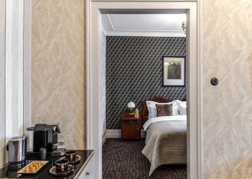 a hotel room with a bed and a coffee maker at Hotel H15 Francuski Old Town - Destigo Hotels in Kraków