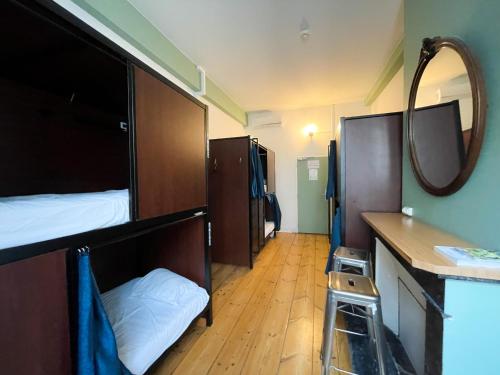 a bedroom with a bunk bed and a mirror at HOSTEL20 Bordeaux HIFRANCE in Bordeaux