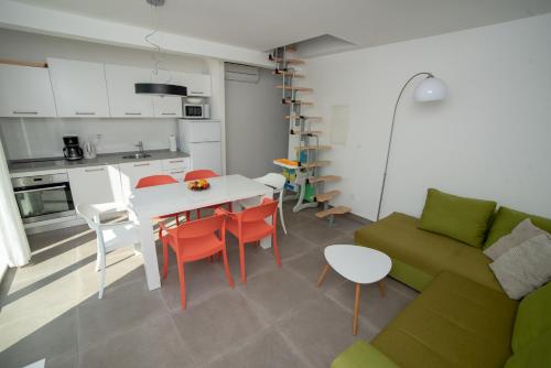 a living room with a couch and a table and chairs at Villa Median in Žman