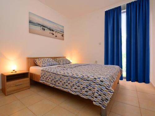 a bedroom with a bed with blue drapes at TOP-APARTMENT MONTENEGRO, with private Pool! in Kumbor