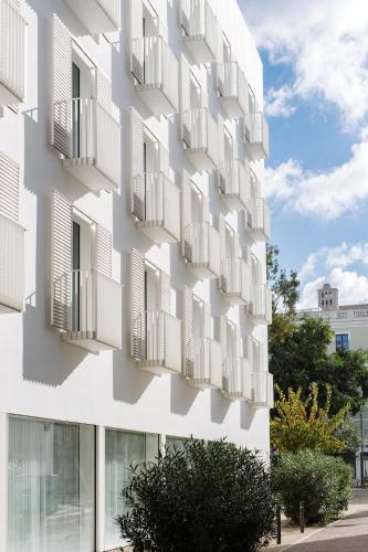 a white building with balconies on the side of it at The Standard, Ibiza in Ibiza Town