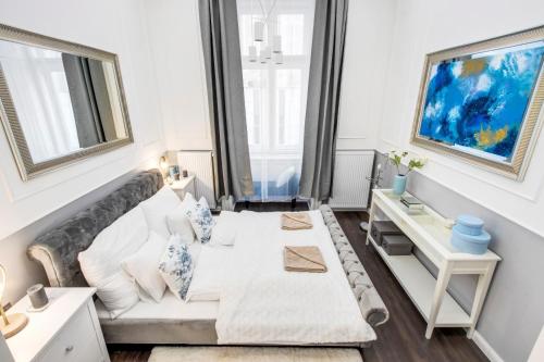 a living room with a couch and a window at A5 Apáczai Apartment in Budapest