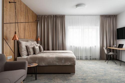 a hotel room with a bed and a couch at Hotel Osvit in Mladá Boleslav