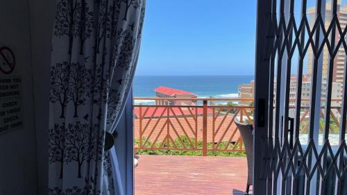 a view of the ocean from a balcony at Victorian Beach Cottages in Amanzimtoti