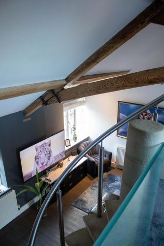 a living room with a staircase with a desk at Tiger Roof Terrace Lymm in Lymm