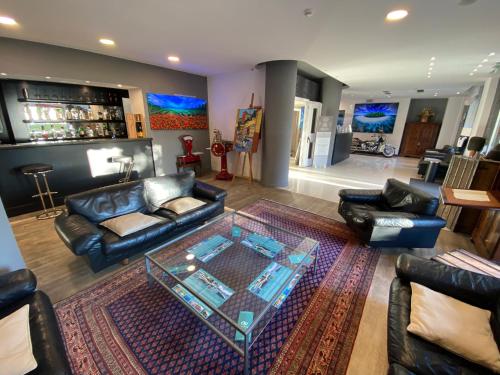 a living room with couches and a glass table at Hotel Astoria in Rapallo