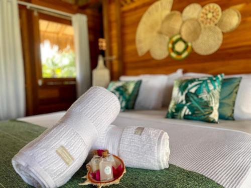 a bandaged up leg on top of a bed at Pousada Casa Caju Bangalows in Cumbuco