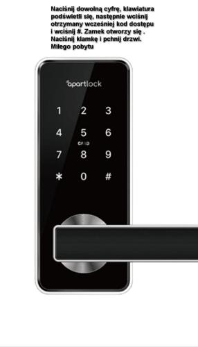 a cell phone with a button on the screen at Cosy Rooms in Piotrków Trybunalski