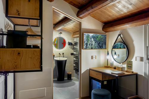 a bathroom with a sink and a mirror at Dimora Bonafede Ibla Design Rooms in Ragusa