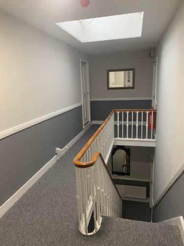 an empty room with a staircase and a stair case at Abbots Mead Hotel in Shrewsbury
