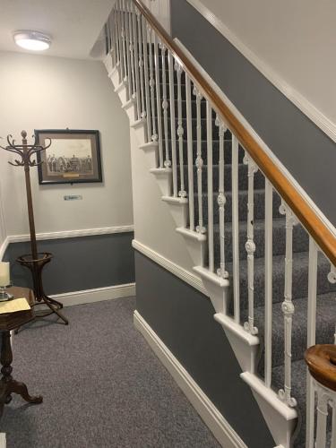 a staircase in a home with a stair case at Abbots Mead Hotel in Shrewsbury