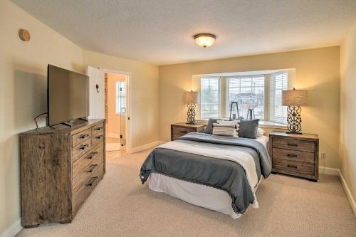 a bedroom with a bed and a television and a dresser at Apt with Balconies - Steps to Kemah Boardwalk! in Kemah