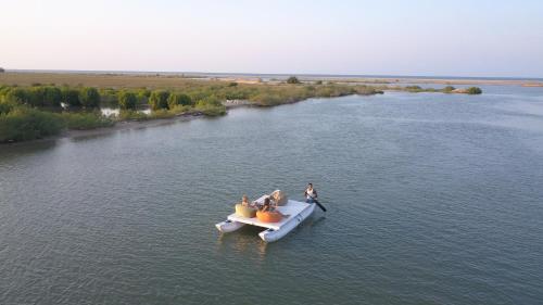 a group of people in a boat on a river at Club Mango Resort in Kalpitiya