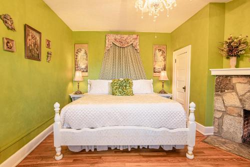 a bedroom with a white bed and a fireplace at Echo Mountain Inn in Hendersonville