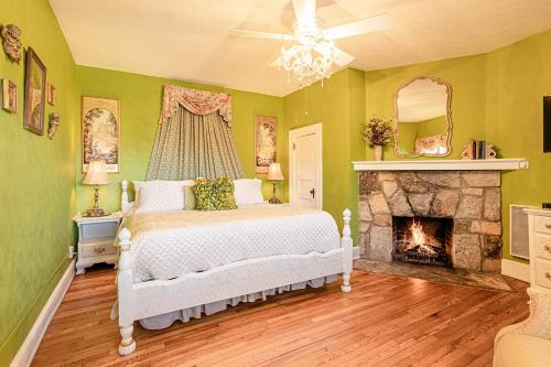 a bedroom with a bed and a fireplace at Echo Mountain Inn in Hendersonville