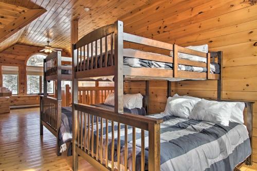 a bedroom with bunk beds in a log cabin at Spacious Winhall Home about 1 Mi to Stratton Mtn! in Stratton Mountain