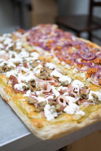 a pizza with ham and cheese on a table at Il Semaforo Sila Hotel in Taverna
