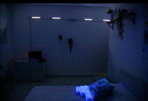 a dark room with a bed and lights on the wall at B&B Damiani in Santa Maria di Castellabate