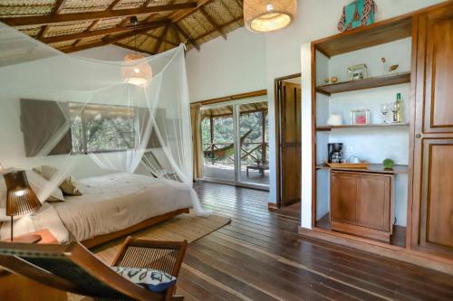 a room with a bed, a table and a window at Reserva Natural Tierra Adentro in Minca