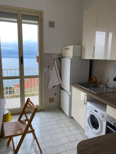 a kitchen with a refrigerator and a sink and a dishwasher at Charmant deux pièces aux portes de Monaco in Cap d'Ail
