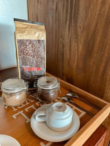 a table with a tea pot and a bag of seeds at Reserva Natural Tierra Adentro in Minca