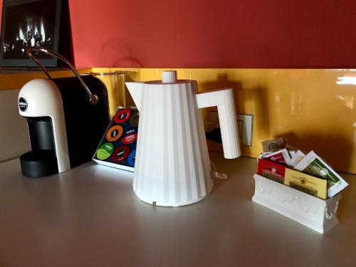 a white lamp sitting on a table next to a box at N°30 CHARME Apartments in Vigevano