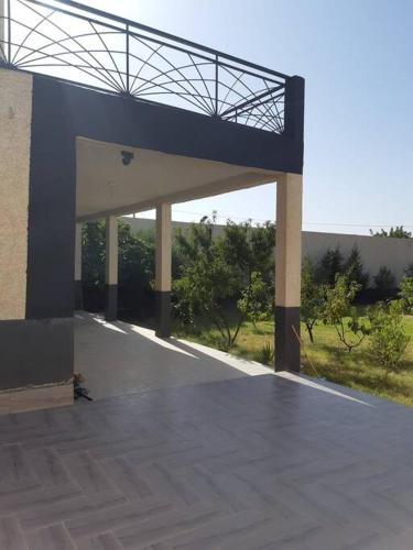 a large building with a blue roof and avisor at VILLA MODERNE in Tahla