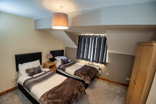 a bedroom with two beds and a window at 21 Killarney Holiday Village in Killarney