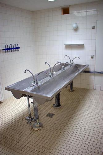 a sink in a bathroom with three faucets at Pinnebergheim in Haderslev