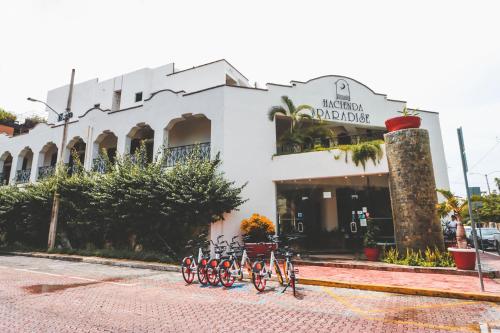 a group of bikes parked in front of a building at Hacienda Paradise Hotel in Playa del Carmen