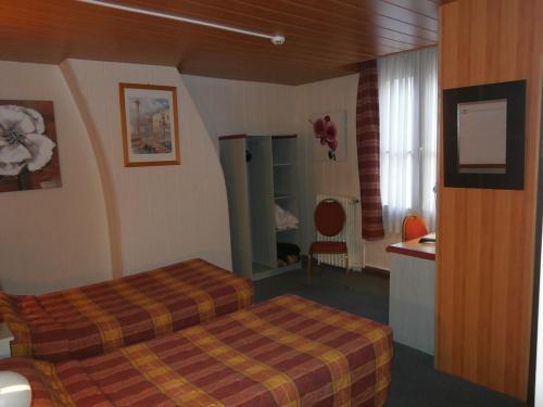 a hotel room with a bed and a sink at Hotel Beausejour in Rouen