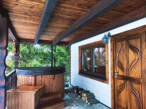 an outside view of a sauna with a wooden door at Dom Malowany in Wetlina