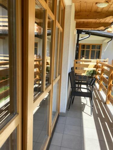 a balcony with two chairs and a table at Apartament Aleksander in Zakopane
