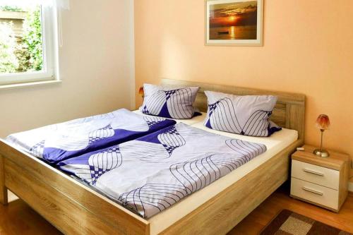 a bed with two pillows on it in a bedroom at Semi-detached house, Lubmin in Lubmin