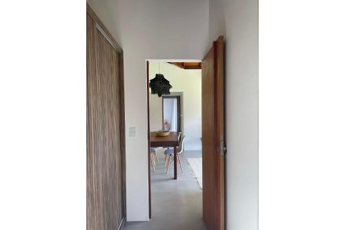 a hallway with a door leading to a dining room at Orixás Residence in Morro de São Paulo