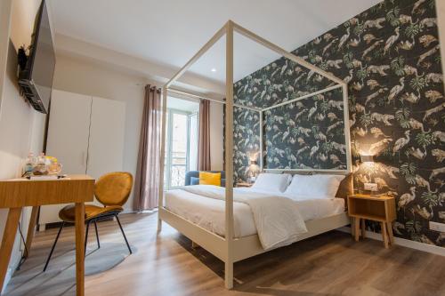 a bedroom with a canopy bed with a floral wallpaper at Design 18 Charming Rooms in Rome