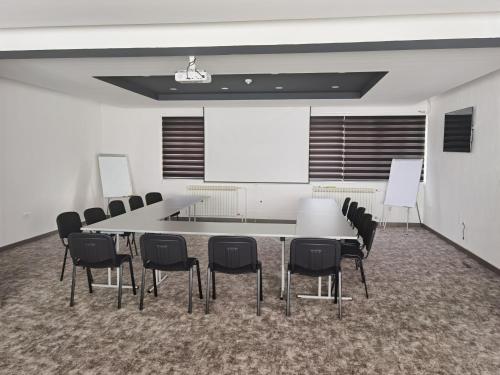 a conference room with a white table and chairs at Hotel Forest in Pale